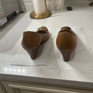 Ladies Tory Burch brown wedges with gold tone emblem
